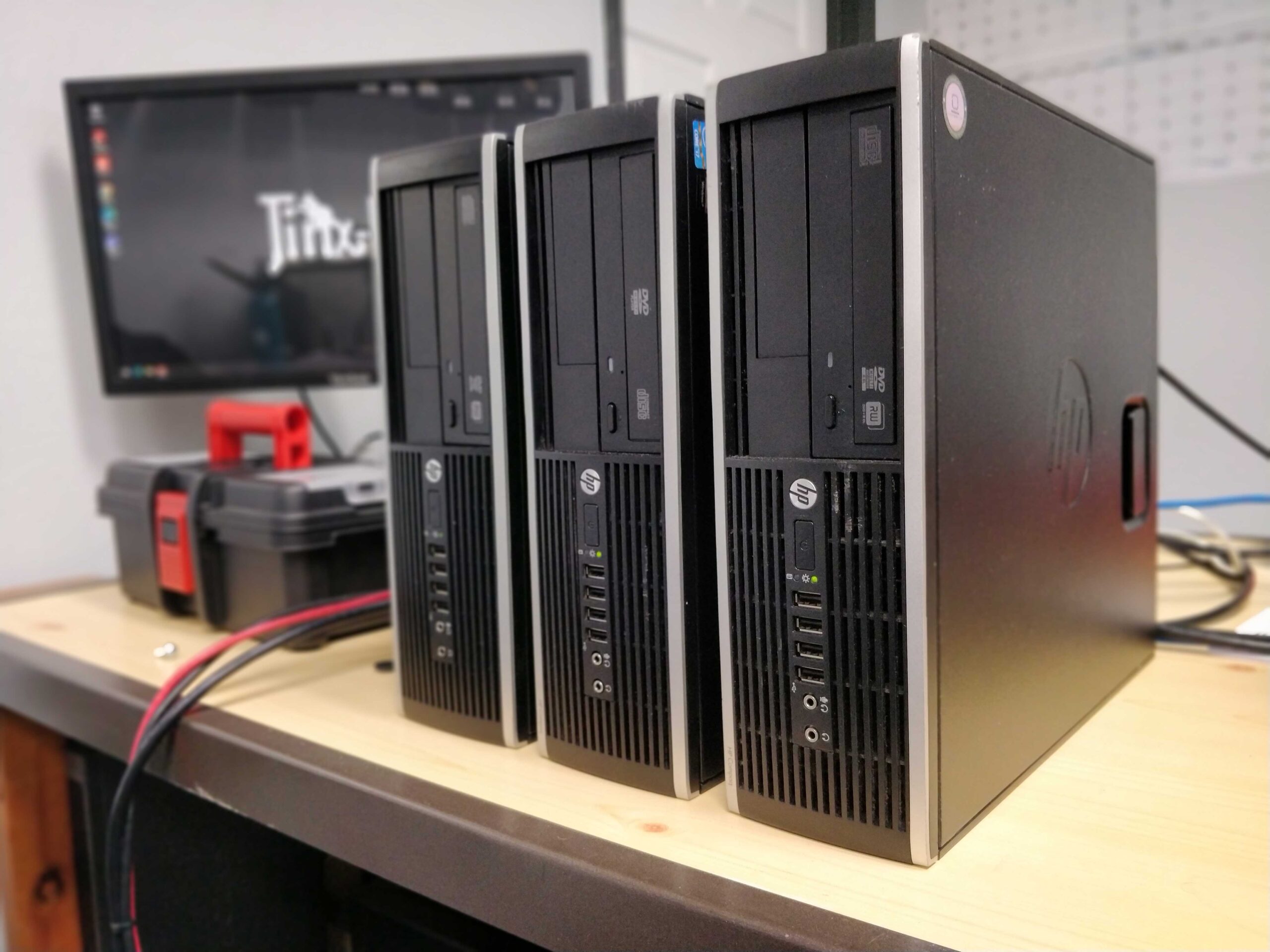 Shows a set of 3 desktop computers and a monitor.
